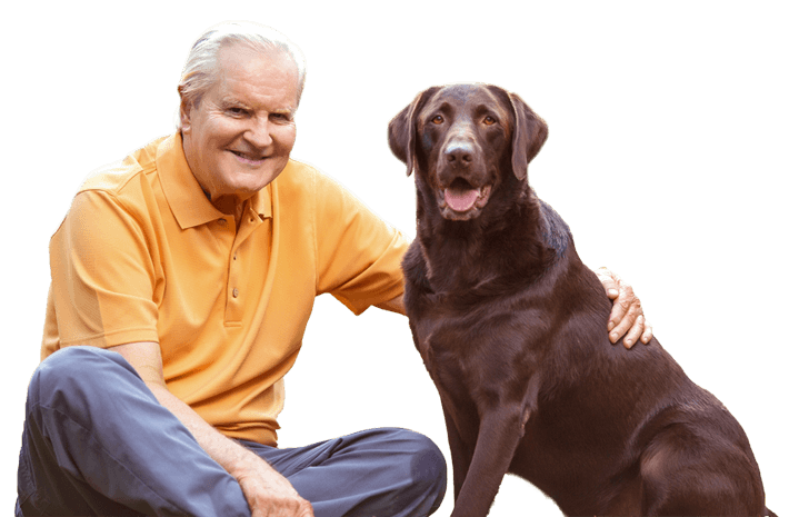 middle aged man sitting next to a dog